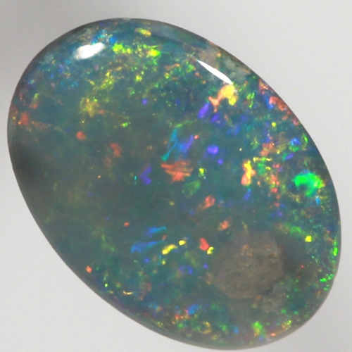SOLID BLACK OPAL Sparkling reds, yellows over ocean blue